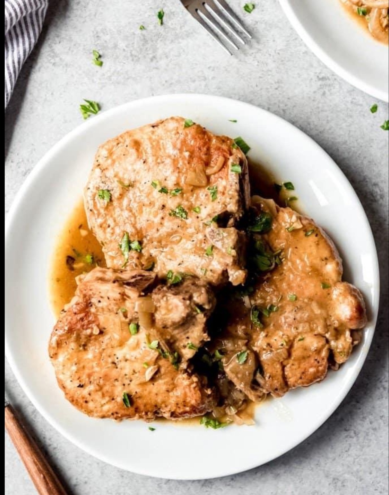 Smothered pork chops in brown gravy
