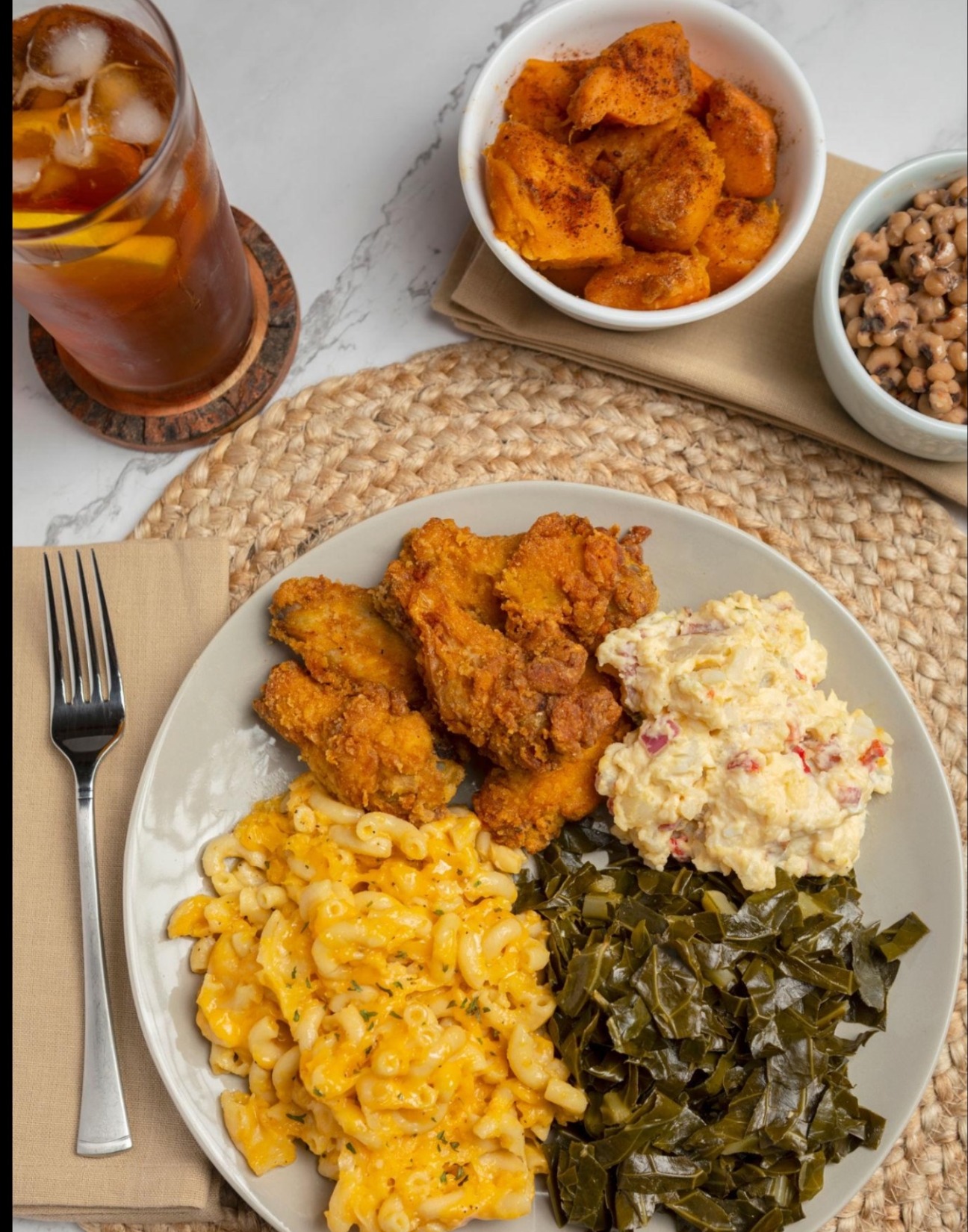 Uncle Willie's Sunday plate — fried chicken, mac & cheese, collard greens, potato salad, with candied yams, black-eyed peas and sweet tea